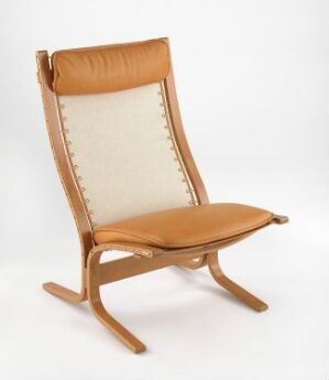  "Siesta" chair by Ingmar Relling, featuring a laminated beech wood frame with a light brown color and natural grain, a tan leather seat and headrest, and a beige canvas backrest with matching crisscross lacing on a white background.