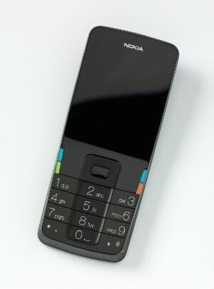  "Prototyp for Nokia" by Norway Says, showing an elegant aluminium mobile phone design with a black perspex display and a minimalist keypad accented with splashes of blue, green, and orange.