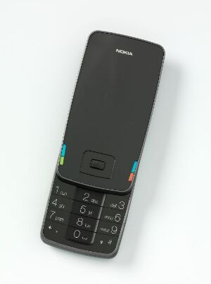  Prototype design for a Nokia mobile phone by Norway Says, featuring a matte black aluminum body with a small screen, backlit numerical keypad, and colorful function buttons against a white background.