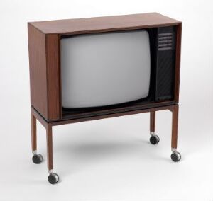  A vintage Henning Moldenhawer-designed television with a cabinet made of dark reddish-brown palisander veneer on slender legs with black caster wheels.