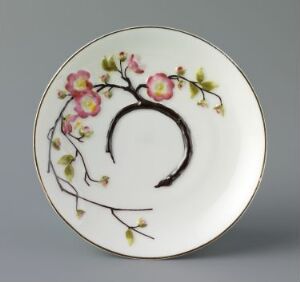  A round feldspar porcelain plate titled "Rosengren" by an unknown artist, featuring a hand-painted relief decoration of a flowering branch in dark brown with soft green leaves and pink blooms, accented with enamel colors and a fine gold rim.