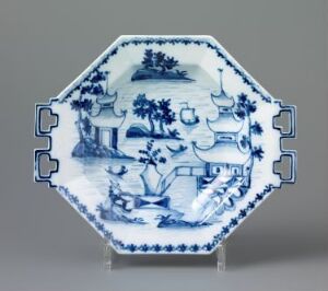  An octagonal ceramic plate with blue and white traditional Chinese design, featuring landscape scenes with pagodas and figures, framed by decorative borders.