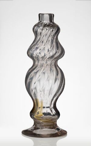  A clear glass bottle or vase with an elegant, hourglass-like shape, featuring twisted striations throughout its body, on a light background with a subtle amber tone at the base.