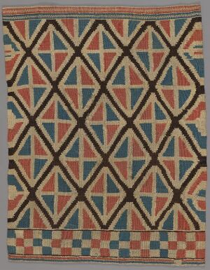  An intricate geometric-patterned textile featuring a trellis-like design with interlocking diamonds and triangles in muted tones of red, blue, beige, and pink, framed by a decorative bordered edge. Artistname and title are unknown.