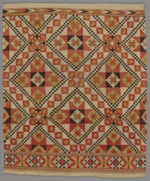  A traditional geometric quilt featuring an intricate pattern of stars and diamonds in warm tones of red, pink, cream, and brown, with a symmetrical array of squares containing detailed radiating designs.