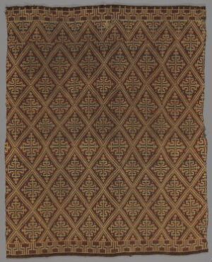  A rectangular textile featuring an intricate geometric pattern with a warm brown gradient background and a border with a different linear motif, demonstrating traditional weaving or embroidery techniques.