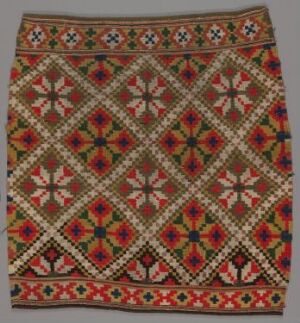  A woven textile featuring an ornate geometric pattern with a beige base and symmetrical designs in shades of brown, red, green, and blue, bordered with a floral or starburst motif in vibrant colors.