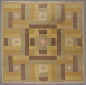  A machine-woven textile design by Halden Bomuldsspinneri & Væveri featuring a symmetrical geometric pattern with squares and rectangles in muted shades of beige, tan, mustard yellow, and brown.