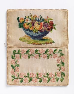  Vintage embroidered fabric possibly functioning as a pouch, featuring a colorful bouquet with fruits and flowers in a blue bowl on the top, and a symmetrical border of pink roses and green vines on the bottom, set against an off-white background.