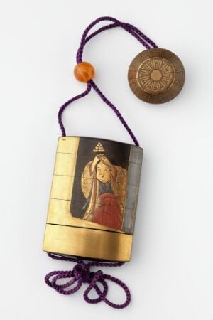  A small rectangular prayer box or amulet case with a golden finish and a depiction of a religious figure in burgundy and gold on the lower half. A deep purple braided cord with a golden bead and an embossed circular item is attached to the top of the case against an off-white background. Artist name and title are unknown.