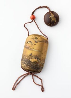  An intricately carved antique ivory-colored inro with a landscape scene, attached to a cord with a dark brown bead, against a white background.