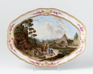  Oval-shaped platter with golden edge and pink floral pattern, featuring a detailed painting of a bucolic village scene with figures in period clothing, structures, and a large, cloudy sky.