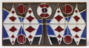  "Treet" by Konrad Galaaen, a decorative art piece made of glazed earthenware with a relief design of a symmetrical tree-like motif in bright red and blue, set in a wooden frame.