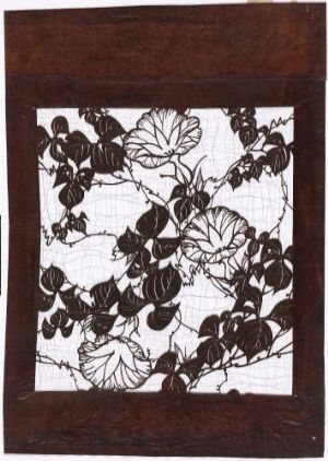  Artwork featuring a square central portion with a detailed black and white pattern of stylized leaves and flowers on a white background, bordered by a broad, warm brown frame suggestive of wood, with no discernible signature or title.