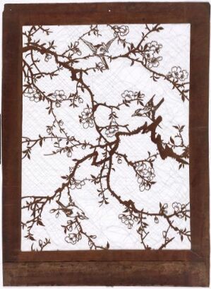  Intricate dark brown or black branches with small blossoms against a stark white background, framed in a rich brown border. The artwork is in a style reminiscent of traditional East Asian paintings or cuttings.