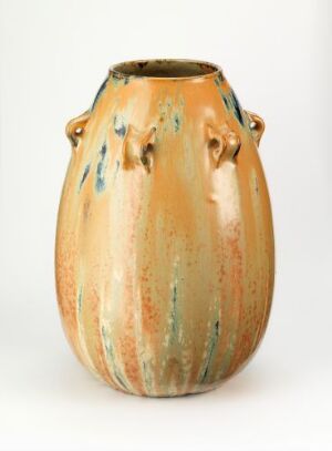  A bulbous golden orange ceramic vase with turquoise blue-green vertical streaks and four symmetrical loop handles near the flared opening against a plain white background. Artist and title are unknown.