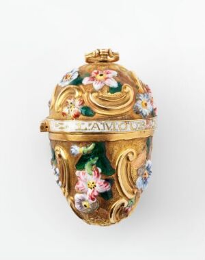  An ornately designed egg-shaped object with a gold base color, featuring elaborate scrollwork and detailed floral motifs in pastel hues, possibly functioning as a decorative piece or container, displayed against a white background.