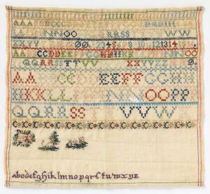  A traditional embroidered sampler with multiple rows of alphabet letters in various fonts and colors, interspersed with decorative patterns, on a light-colored fabric.