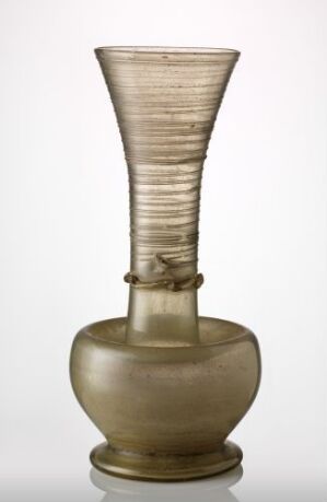  An elegant glass vase with a bulbous olive-hued base and a ridged ivory upper section, on a neutral light grey background.