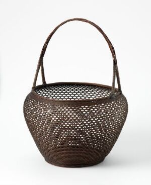  A dark brown basket with a rounded shape and a handle, featuring a pattern of small, uniform holes throughout its surface.