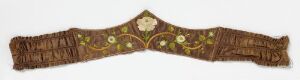  An elongated dark brown decorative textile with symmetrical cream floral motifs and olive green leaf patterns, accented with golden-yellow embellishments, tapering at both ends, which could be a traditional belt or waistband.