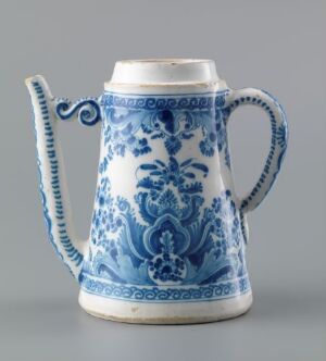  A traditional blue and white ceramic jug with a scrolled handle and decorative floral patterns, set against a solid, neutral background.