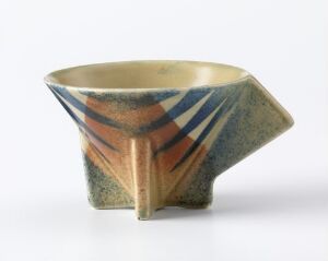 
 A small molded and glazed flintgods cup or bowl by Egersunds Fayancefabrik with an abstract design in beige, green, blue, and orange, featuring a unique triangular side protrusion and smooth, glossy finish.