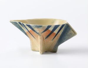  A triangular prism-shaped piece of cast and glazed flint clay tableware with geometric spray decorations in blue and reddish-brown by Egersunds Fayancefabrik.