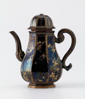  A traditional style coffee pot with a glossy midnight blue body and gold floral patterns, featuring a contrasting dark brown handle, on a light grey background. Artist name and title are unknown.