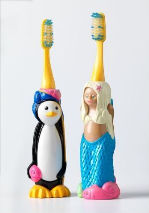  Two playful toothbrushes with rubber-coated molded plastic handles; one designed as a penguin wearing a purple hat, with a black, white, and yellow body, and the other as a mermaid with blonde hair, a turquoise tail, and pink starfish accessory, both with yellow bristles featuring highlighted tips. Artist name: Geir Øxseth.