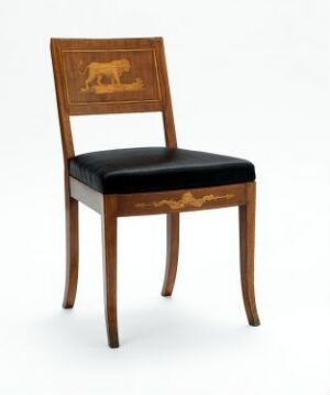  An elegant wooden chair with a lion motif inlaid or gilded on the backrest, black upholstered seat, and golden scrollwork trim against a plain light background.