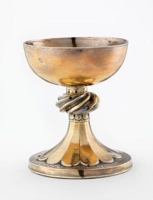  A silver chalice known as "Børsa-kalken" featuring a gold-washed interior and a gilded decorative stem, with an evident patina on its elaborately engraved and chased exterior. The artist remains unidentified.