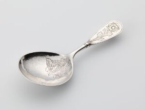  An antique silver spoon with an embossed butterfly in the bowl and the year "1898" engraved on the ornate handle, against a plain, light-colored background.