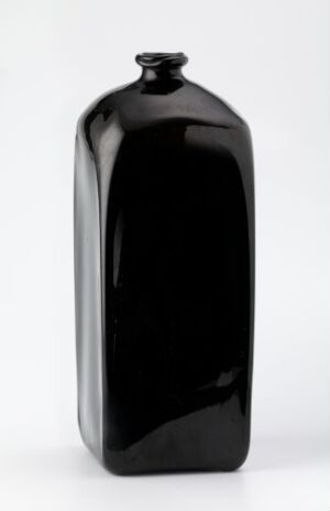  A lustrous black, rectangular vase with a glossy finish and a small rounded stopper at the top, set against a plain light background, exemplifying minimalist elegance.