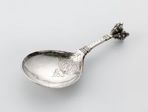  An ornate silver spoon, titled "Skje" by Rasmus Gullsmed, with an elegant engraved handle and decorative finial, crafted using traditional silver smithing techniques, lying against a neutral background.