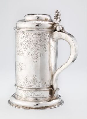  Silver drinking pitcher "Drikkekanne" by Jochum Jochumsen Kirsebom, featuring engraved patterns, a curved handle, and a decorative lid, set against a plain background that accentuates its gleaming surface.