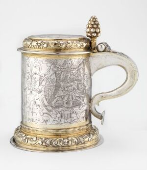  An ornate silver drinking pitcher called "Drikkekanne" by an unidentified artist, with embossed and engraved designs, gilded accents, and a fruit-like finial on the lid, showcasing the intricate artistry of metalwork.