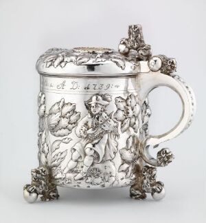  An intricately designed silver drinking jug titled "Drikkekanne" by Berendt Johansen, featuring embossed and engraved floral designs, with pronounced three-dimensional details on the handle, lid, and base, suggesting a combination of chased, engraved, and possibly repoussé silverwork techniques.