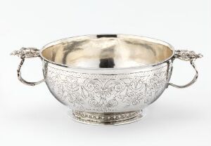  "Øreskål" by Rasmus Gullsmed, a silver serving bowl with ornate floral engravings and intricate handles designed for tableware, displaying the craft of repoussé, casting, soldering, and engraving of silver.