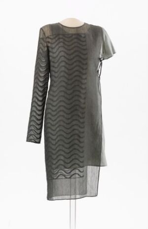  A knee-length gray dress with a round neckline and full-length sleeves showcasing a monochromatic wavy zigzag pattern, displayed on a stand against a light background.