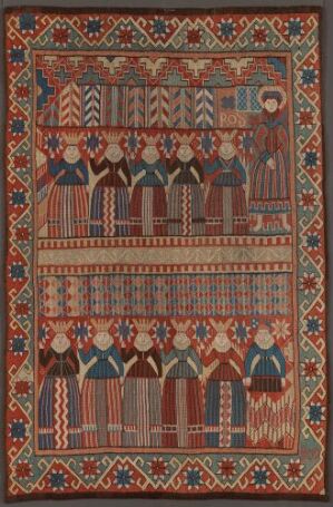  A traditional textile featuring horizontal bands of intricate patterns and human figures. The color scheme includes deep browns, blues, reds, greens, and oranges with symmetrical designs, possibly indicating the textile's cultural significance.