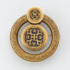  An intricate golden brooch with a central dark blue and gold cross design set within multiple concentric circles of detailed metalwork, featuring a small identical motif attached at the top.