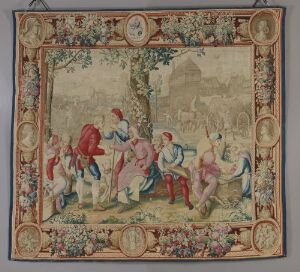  A handwoven tapestry in gobelin technique by Les Gobelins fabrikken, Paris, depicting a pastoral scene with a group of elegantly dressed figures in a natural setting, framed by an ornate border with floral patterns and medallions.