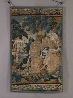  An intricate historical tapestry featuring two noble figures amidst a wooded scene with rich greenery, along with detailed borders with plant motifs in dark blue and gold.