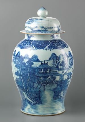  Traditional blue and white porcelain jar with intricate hand-painted designs, featuring a detailed landscape scene with architectural structures and foliage.