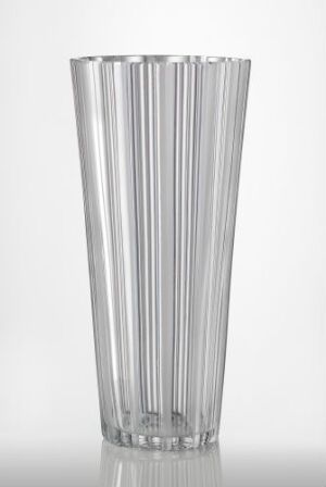  A clear glass vase with vertical ridges, widening from base to top, against a light background.