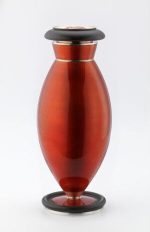  A sleek, tapered vase with a rich red gradient and glossy finish, accented with black bands at the neck and base, and a black lid, set against a plain background. Artist name and title are unknown.