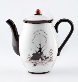  A porcelain teapot by Porsgrunds Porselænsfabrik AS with a white glossy finish, featuring a hand-painted, monochrome winter scene with a tree, cabin, and pine trees, accented with a black spout, handle, and a red finial on the lid.