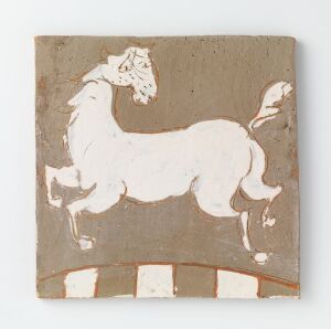  A simplistic, folk-art style ceramic square featuring a stylized white horse on a brown background, with exaggerated features and a playful stance, standing above a series of white rectangular shapes that suggest a baseline or ground.