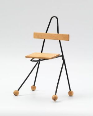  A unique chair designed by Terje Ekstrøm featuring a minimalist structure with black, soldered metal rods for the legs and backrest, a flat wooden seat, and wooden spheres as feet, all set against a simple off-white background.